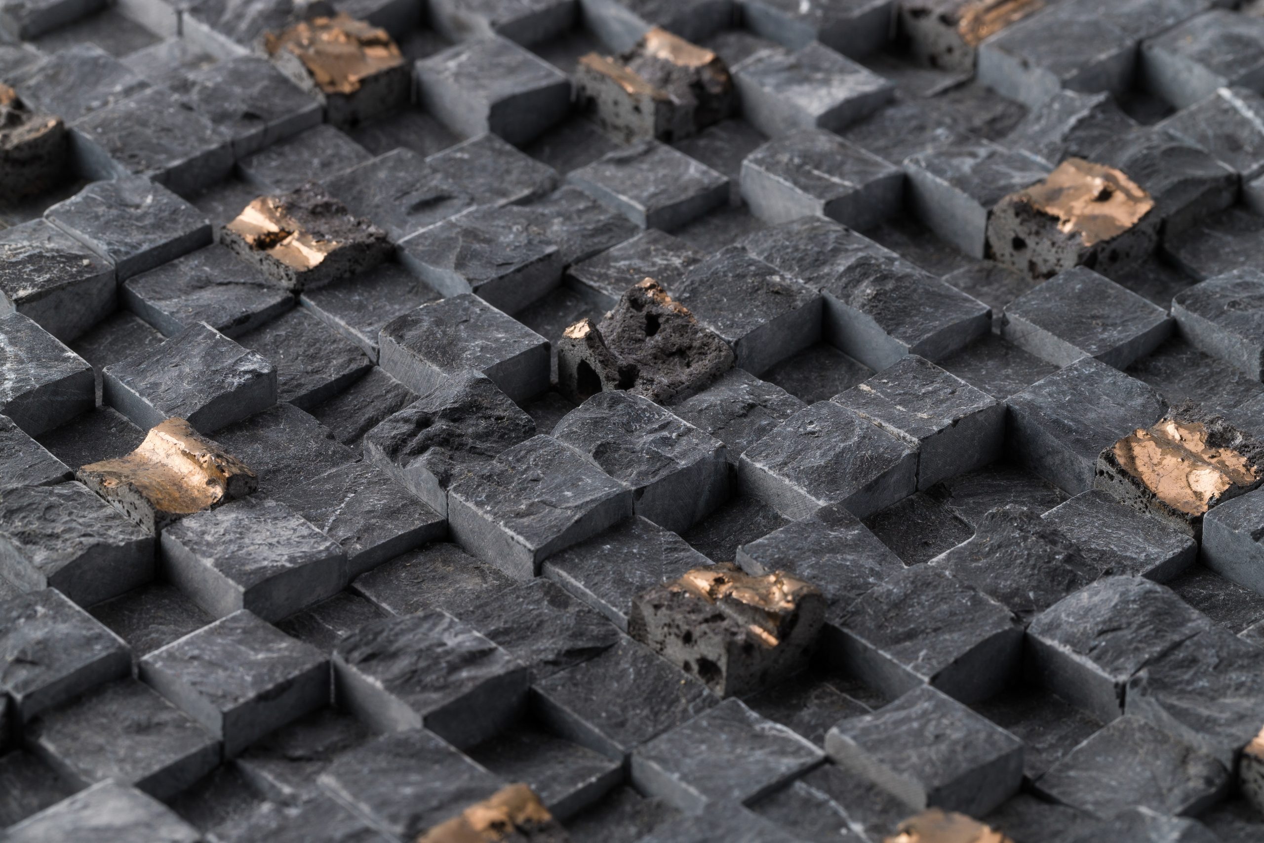 A closeup of old black square tiles of a wall under the lights - cool for wallpapers